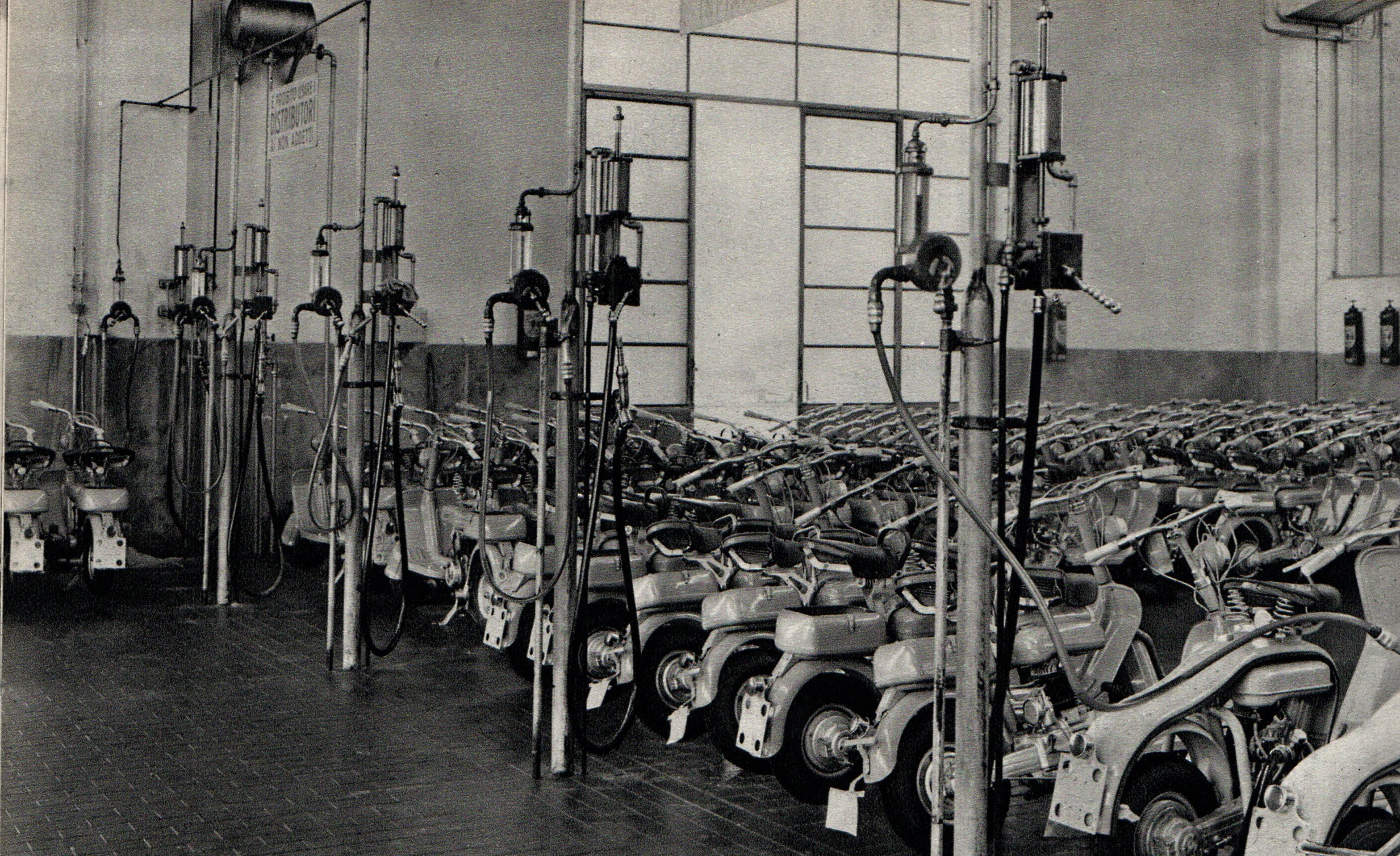 Rows of completed Lambretta scooters awaiting fuel supply before dynamometer testing at the Innocenti Works