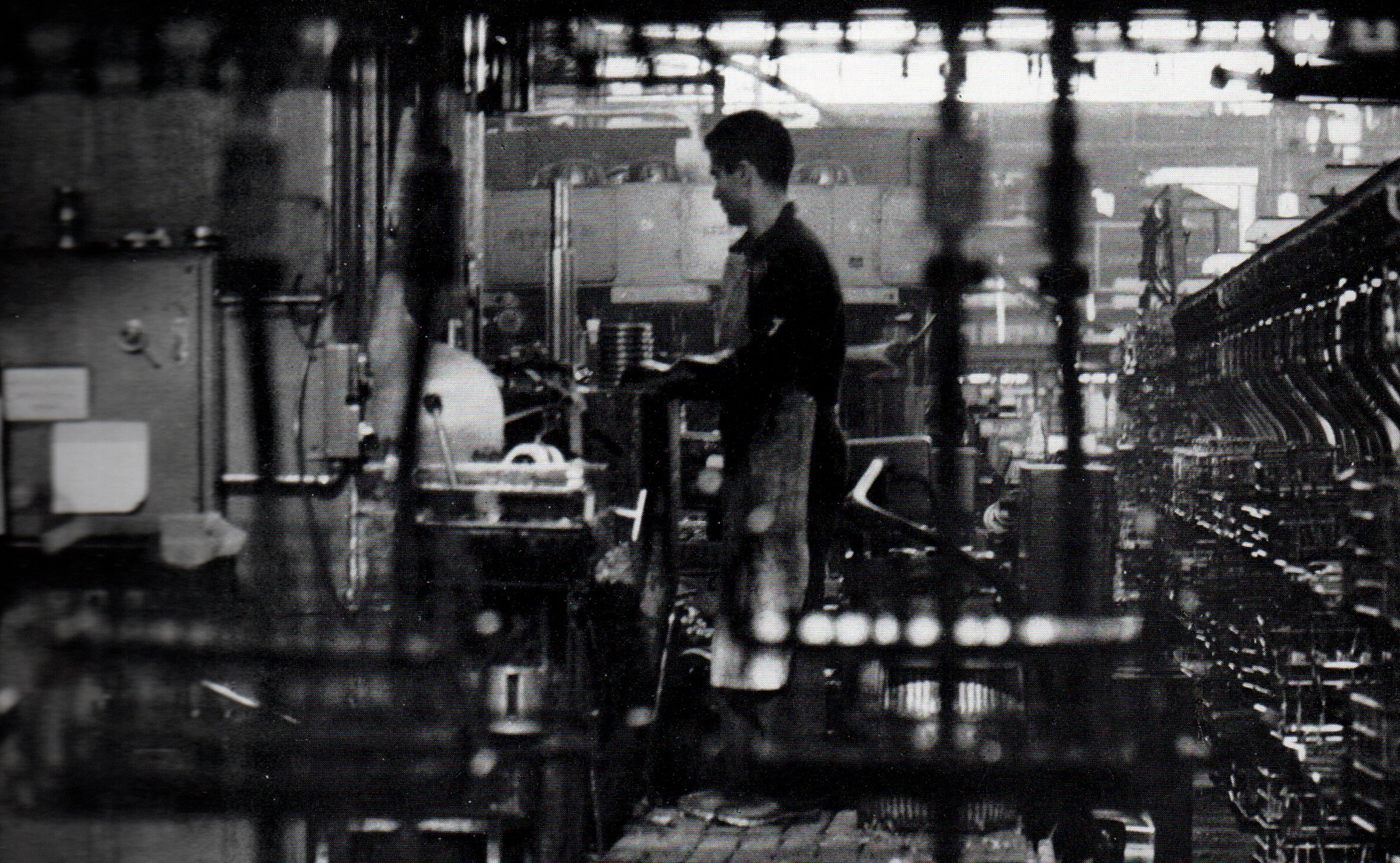 Machinist operating machines in the scooter production lines at Lambrate